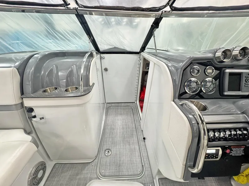 Slide: The Image of Interior of a 2013 Formula 290 Bowrider boat, featuring sleek dashboard and cup holders. - 45