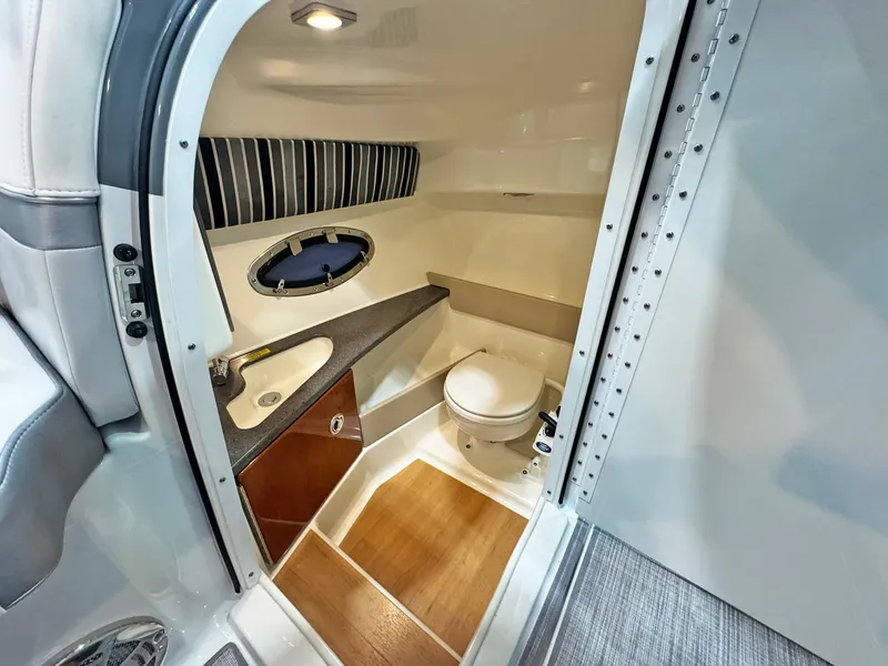 Slide: The Image of 2013 Formula 290 Bowrider bathroom with sink, toilet, and wood flooring. - 46