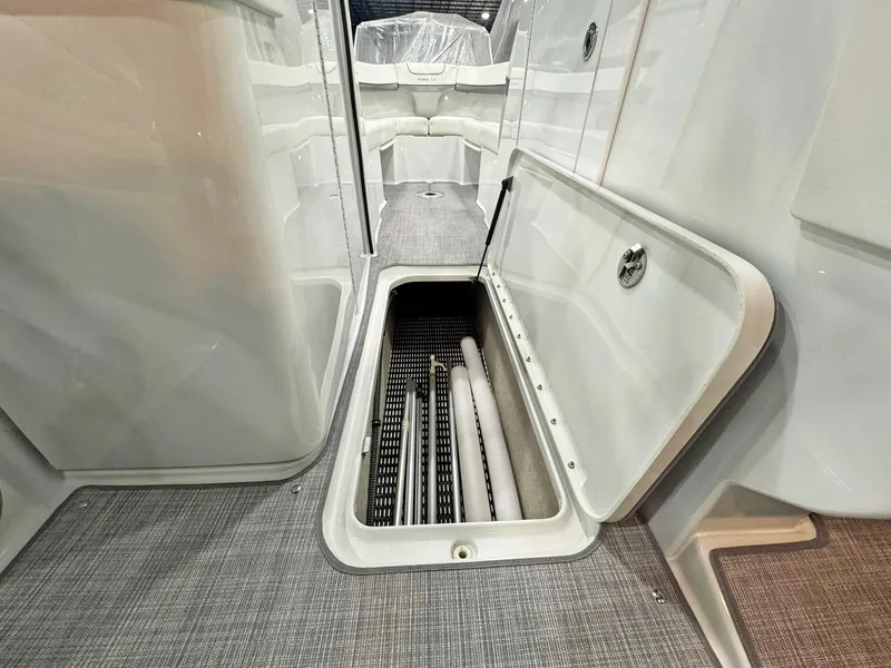 Slide: The Image of 2013 Formula 290 Bowrider interior storage compartment with open hatch, showcasing spacious design. - 49