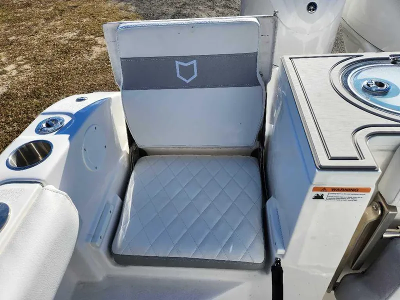 Slide: The Image of 2025 Sea Fox 288 Commander boat seat with cup holders and storage compartment. - 10