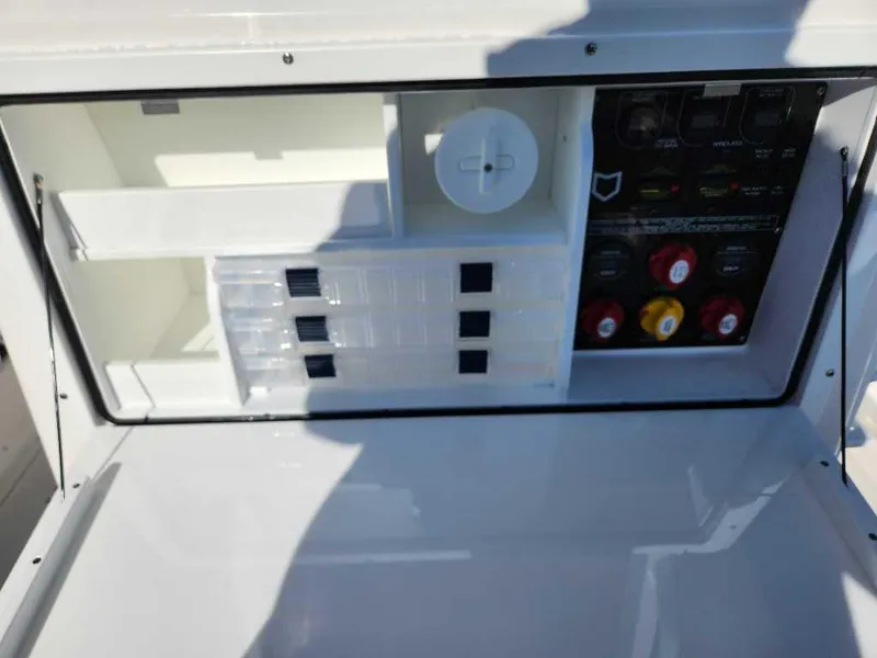 Slide: The Image of 2025 Sea Fox 288 Commander control panel with storage compartments and switches. - 18