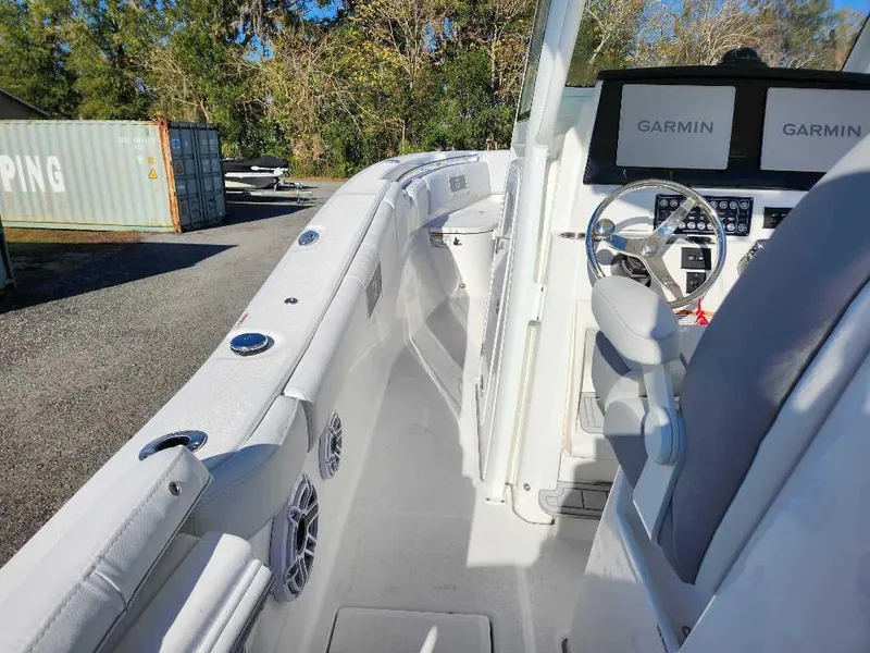 Slide: The Image of 2025 Sea Fox 288 Commander boat interior with Garmin navigation system, steering wheel, and seating. - 20