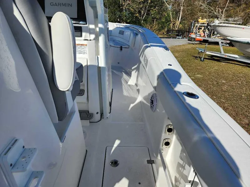Slide: The Image of 2025 Sea Fox 288 Commander boat interior with Garmin equipment, docked outdoors. - 21