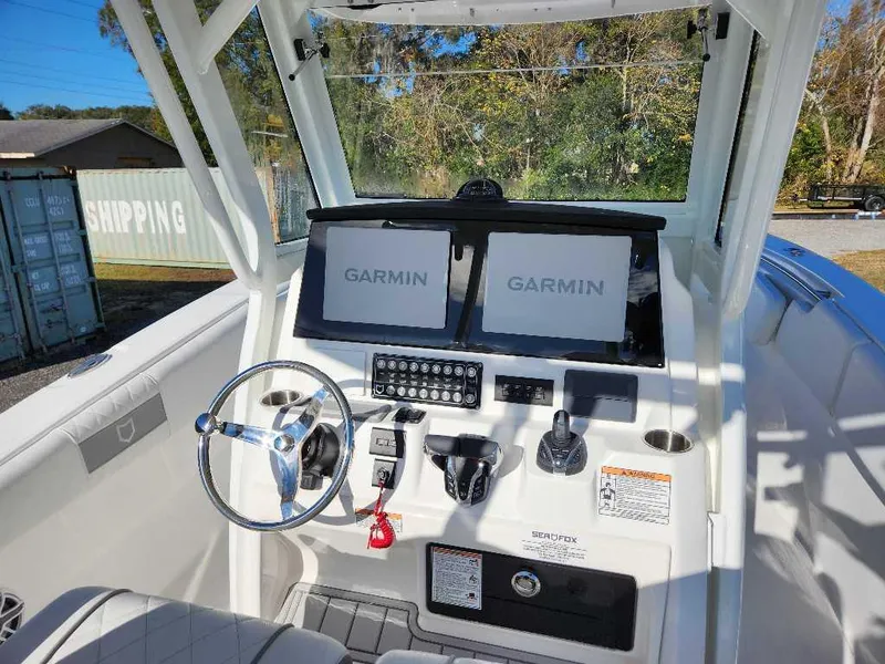Slide: The Image of 2025 Sea Fox 288 Commander helm with Garmin displays and modern controls. - 22