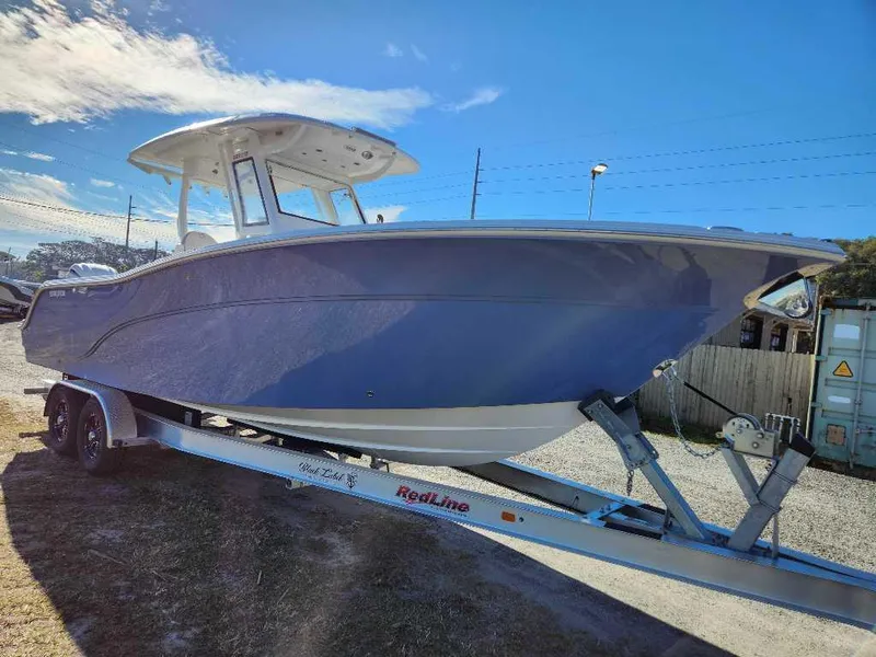 Slide: The Image of 2025 Sea Fox 288 Commander boat on trailer under clear blue sky. - 4