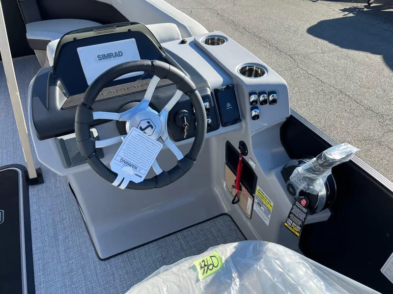 Slide: The Image of 2025 Harris Cruiser 230 boat dashboard with steering wheel and controls. - 10