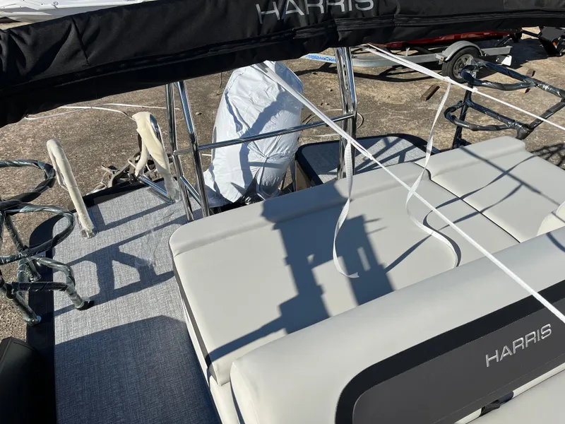 Slide: The Image of 2025 Harris Cruiser 230 boat interior with seating and railing, featuring a sleek design. - 9