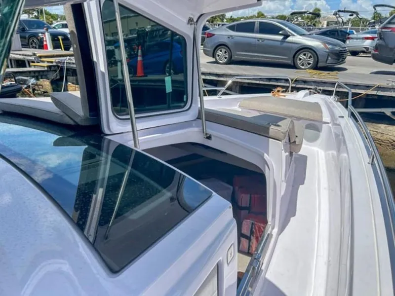 Slide: The Image of 2024 Axopar 45 XC Cross Cabin boat docked, showcasing sleek design and spacious deck. - 10