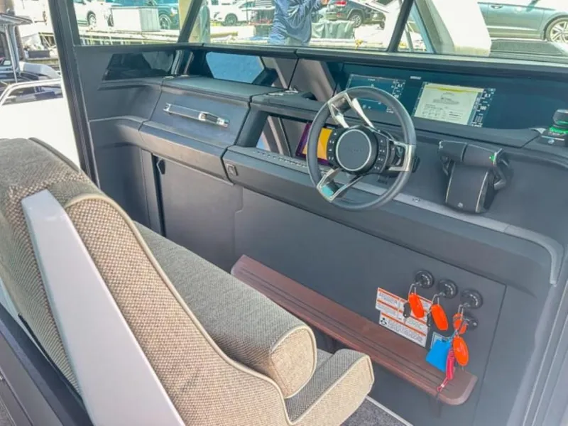 Slide: The Image of 2024 Axopar 45 XC Cross Cabin interior with modern steering and dashboard controls. - 13