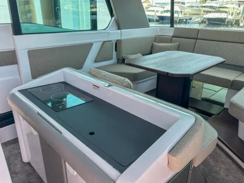 Slide: The Image of 2024 Axopar 45 XC Cross Cabin interior with seating and table. - 21