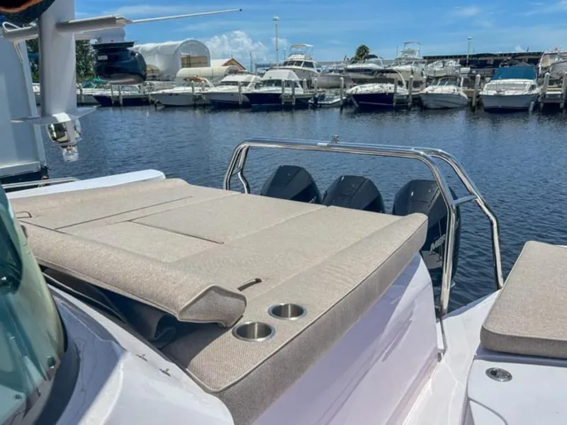 Slide: The Image of 2024 Axopar 45 XC Cross Cabin boat with sun deck and marina view. - 28