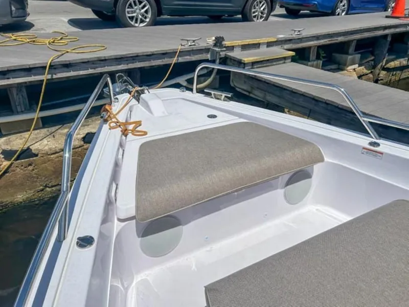 Slide: The Image of 2024 Axopar 45 XC Cross Cabin boat docked, featuring cushioned seating and sleek design. - 6