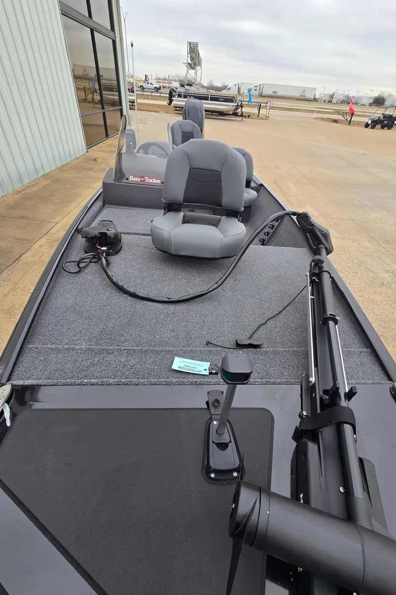 Slide: The Image of 2025 Tracker Bass Tracker Classic XL boat with gray seating and fishing equipment. - 4
