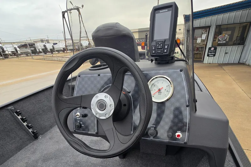 Slide: The Image of 2025 Tracker Bass Tracker Classic XL dashboard with steering wheel and navigation display. - 5
