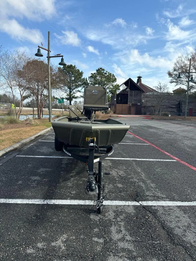 Slide: The Image of 2025 Tracker Grizzly 1650 T Prairie Wings Edition boat parked outdoors on asphalt. - 3