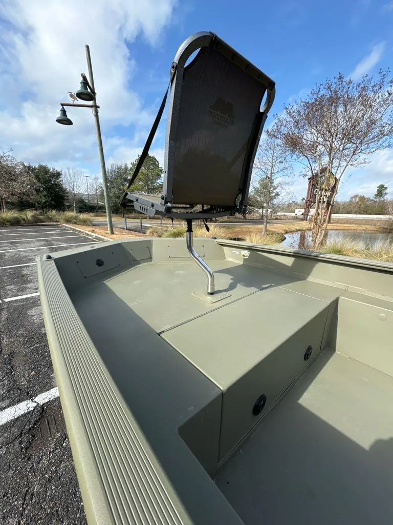 Slide: The Image of 2025 Tracker Grizzly 1650 T Prairie Wings Edition boat, featuring a raised seat, parked outdoors. - 4