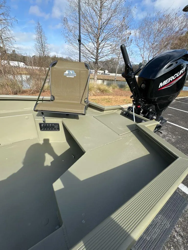 Slide: The Image of 2025 Tracker Grizzly 1650 T Prairie Wings Edition boat with Mercury engine, parked outdoors. - 6