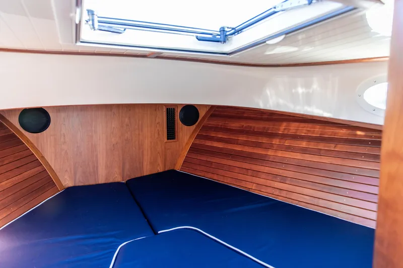 Slide: The Image of Interior view of 2022 Hinckley Picnic Boat 34 S, featuring wood paneling and ceiling hatch. - 21