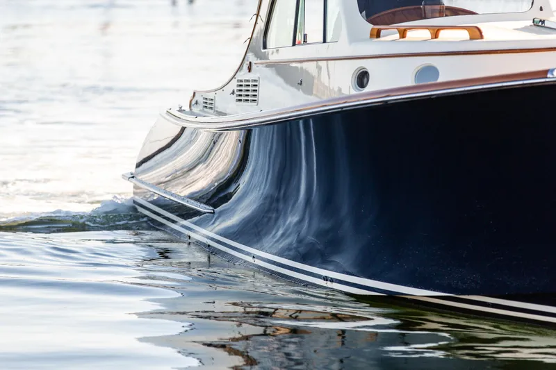 Slide: The Image of 2022 Hinckley Picnic Boat 34 S galley with sink, microwave, and wooden cabinetry. - 3