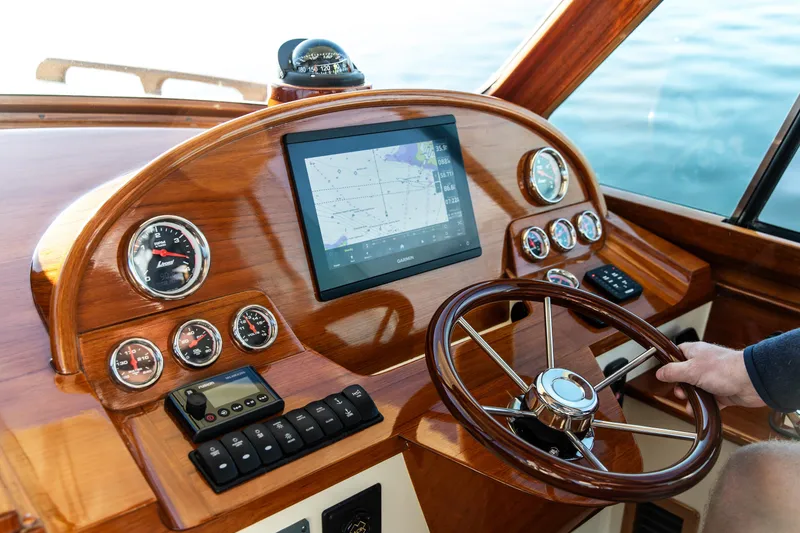 Slide: The Image of Interior of 2022 Hinckley Picnic Boat 34 S with striped seating and American flag. - 14