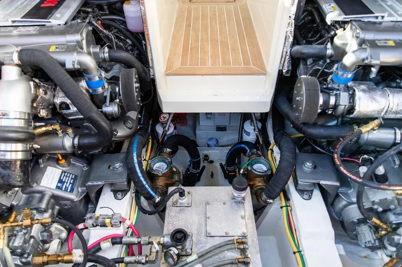 Slide: The Image of Engine compartment of a 2022 Hinckley Picnic Boat 34 S, showcasing dual engines and mechanical components. - 24