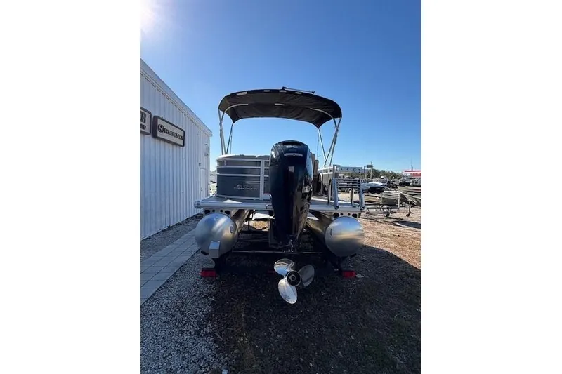 Slide: The Image of 2025 Sun Tracker Party Barge 20 DLX pontoon boat, rear view with canopy and motor. - 3