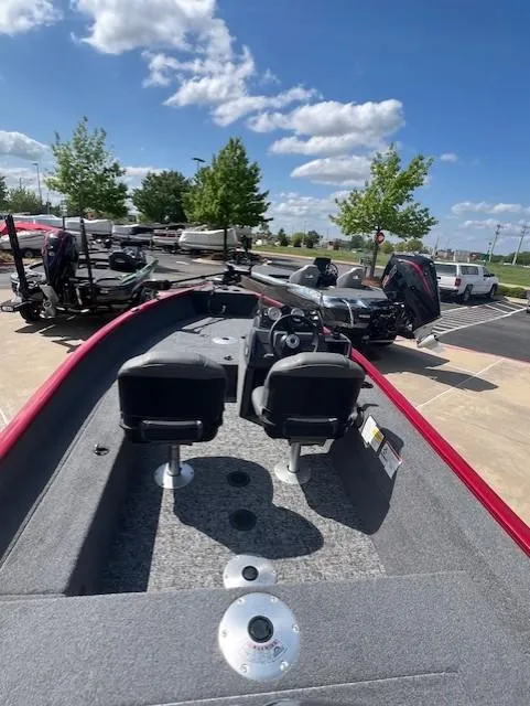 Slide: The Image of 2025 Tracker Super Guide V-16 SC boat with dual seats, parked outdoors under a clear sky. - 3