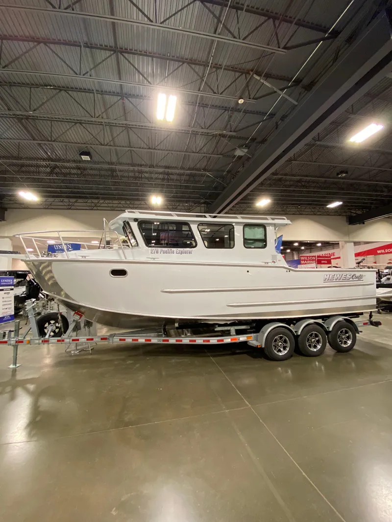 The Image of 2025 Hewescraft 270 Pacific Explorer ET HT boat on display indoors. - 0