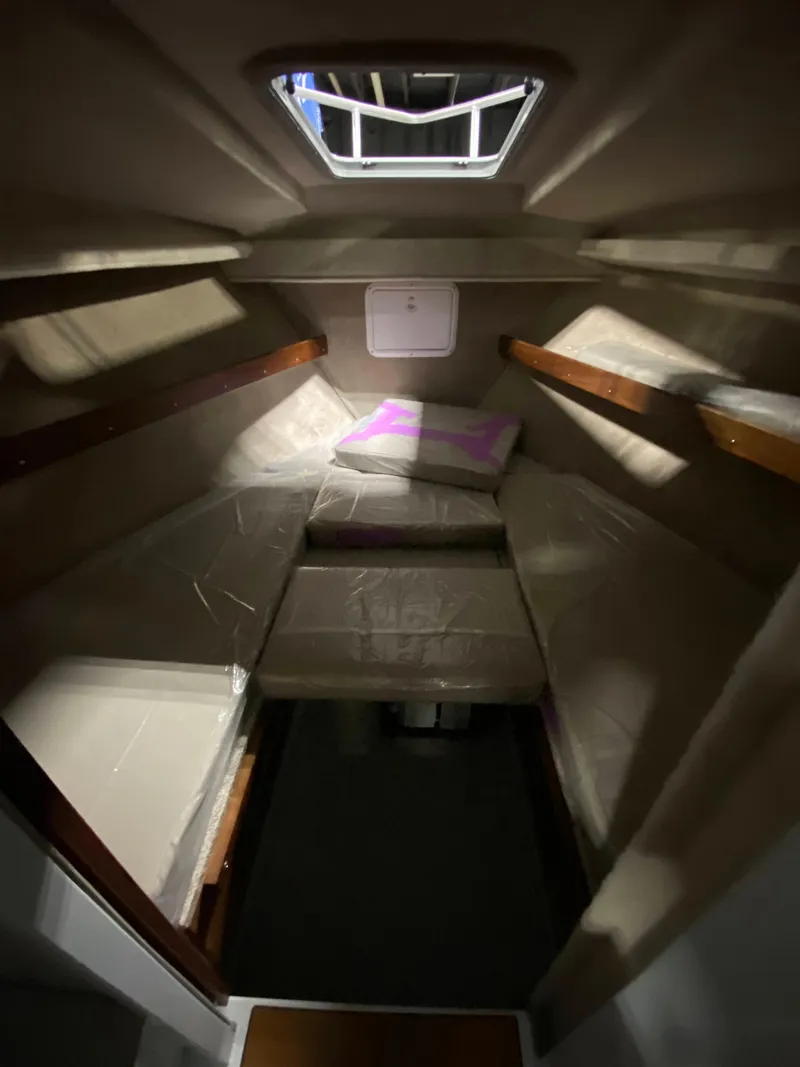 Slide: The Image of 2025 Hewescraft 270 Pacific Explorer ET HT cabin interior with cozy sleeping area. - 10