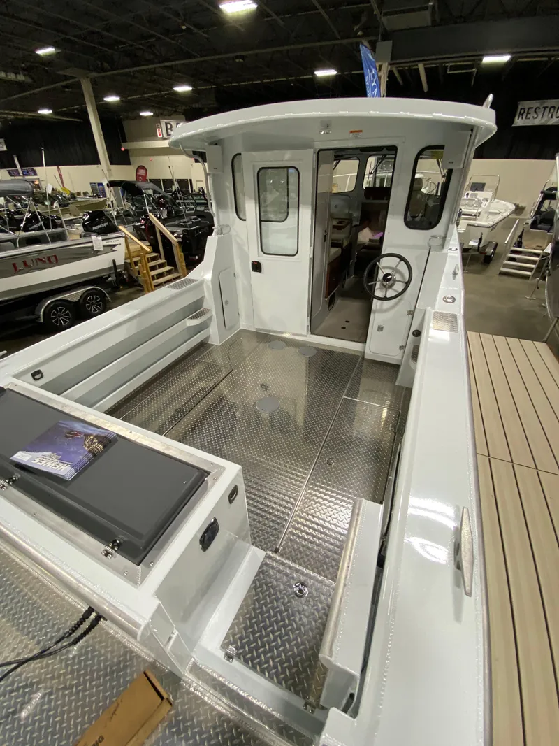 Slide: The Image of 2025 Hewescraft 270 Pacific Explorer ET HT boat interior at a showroom display. - 3