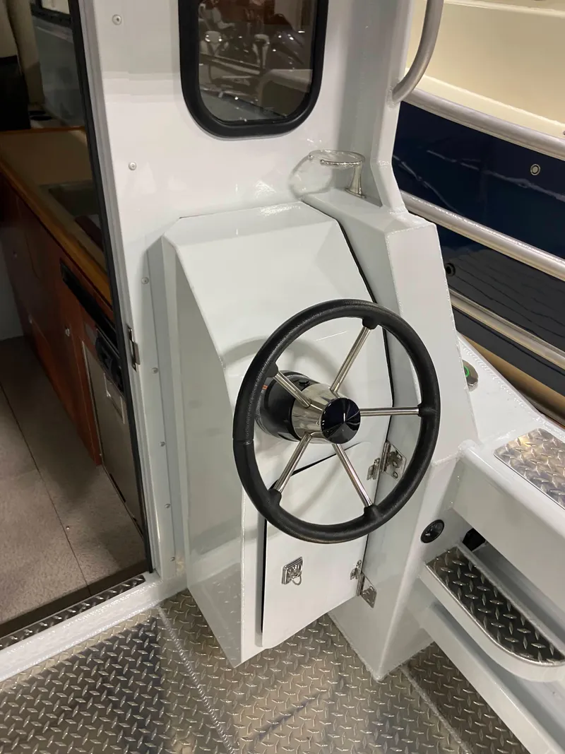 Slide: The Image of Steering wheel of 2025 Hewescraft 270 Pacific Explorer ET HT boat, interior view. - 5