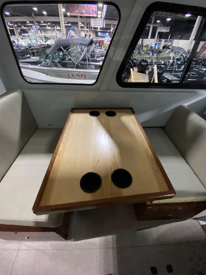 Slide: The Image of Interior of 2025 Hewescraft 270 Pacific Explorer ET HT with table and seating. - 9