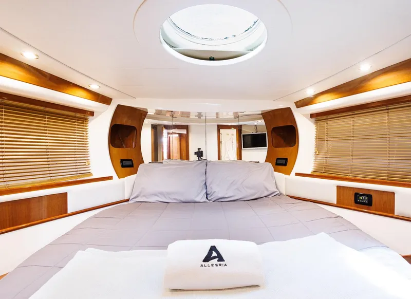 Slide: The Image of Luxurious interior of 2008 Pershing 50 yacht with elegant bedding and wooden accents. - 14