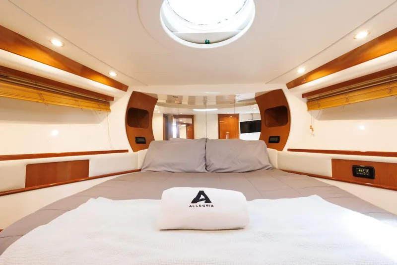 Slide: The Image of Luxurious interior of a 2008 Pershing 50 yacht, featuring a cozy bed and elegant design. - 16