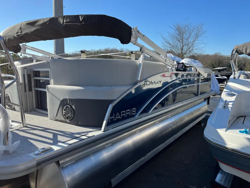 Slide: The Image of 2025 Harris Cruiser 230 pontoon boat with sleek design and spacious deck. - 4