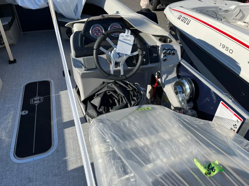 Slide: The Image of 2025 Harris Cruiser 230 boat interior with steering wheel and dashboard controls. - 6