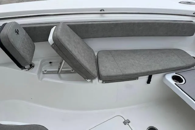 Slide: The Image of 2024 Sea Pro 262 Deluxe CC boat seating with gray cushions and cup holders. - 11