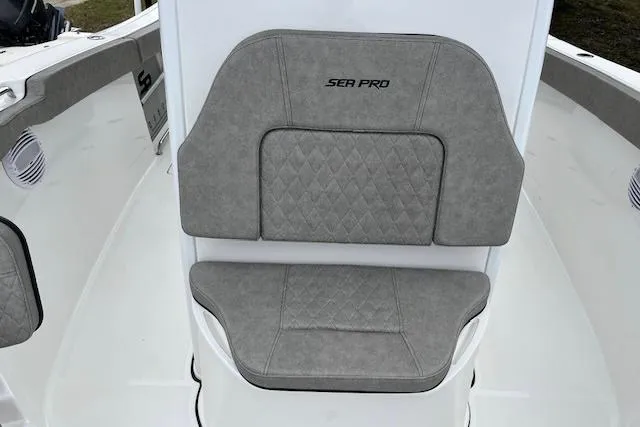 Slide: The Image of 2024 Sea Pro 262 Deluxe CC boat seat with gray diamond-pattern upholstery. - 12