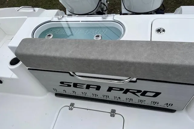 Slide: The Image of 2024 Sea Pro 262 Deluxe CC boat with branded livewell and measurement markings. - 15