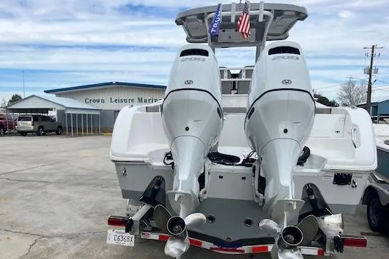 Slide: The Image of 2024 Sea Pro 262 Deluxe CC boat with dual engines at marina. - 4