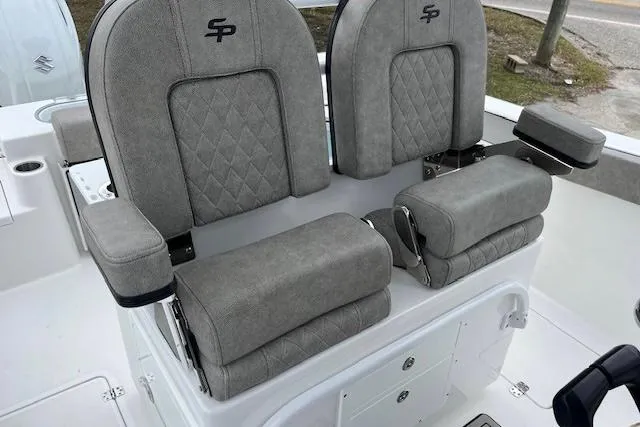 Slide: The Image of 2024 Sea Pro 262 Deluxe CC boat seats with gray upholstery and diamond stitching. - 8