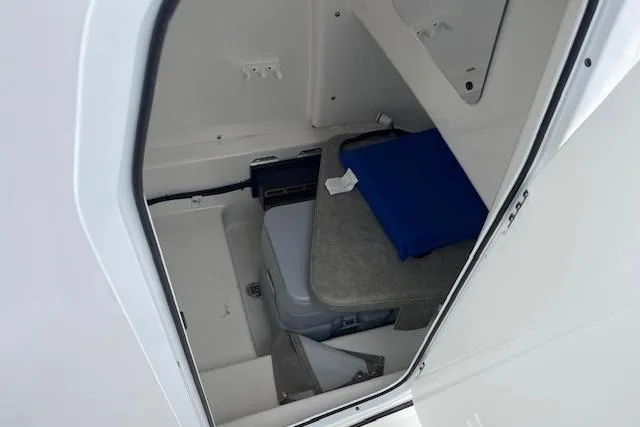 Slide: The Image of 2024 Sea Pro 262 Deluxe CC cabin interior with seating and storage. - 9