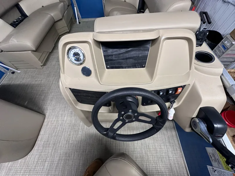 Slide: The Image of 2022 Starcraft LX 18 R boat dashboard with steering wheel and control panel. - 3