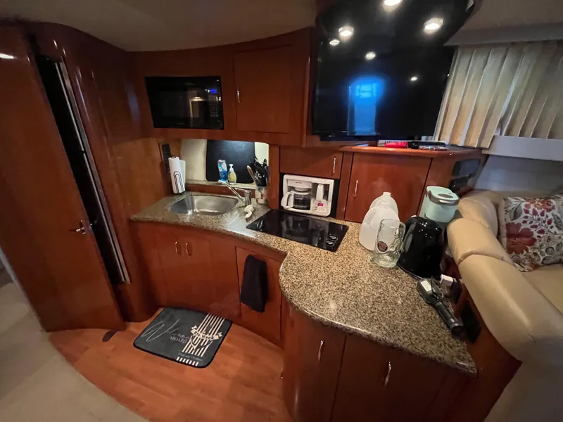 Slide: The Image of 2005 Carver 36 Mariner kitchen with wood cabinets, granite countertops, and modern appliances. - 13