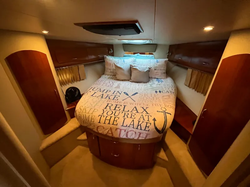Slide: The Image of Interior cabin of 2005 Carver 36 Mariner with cozy bed and wooden storage. - 15