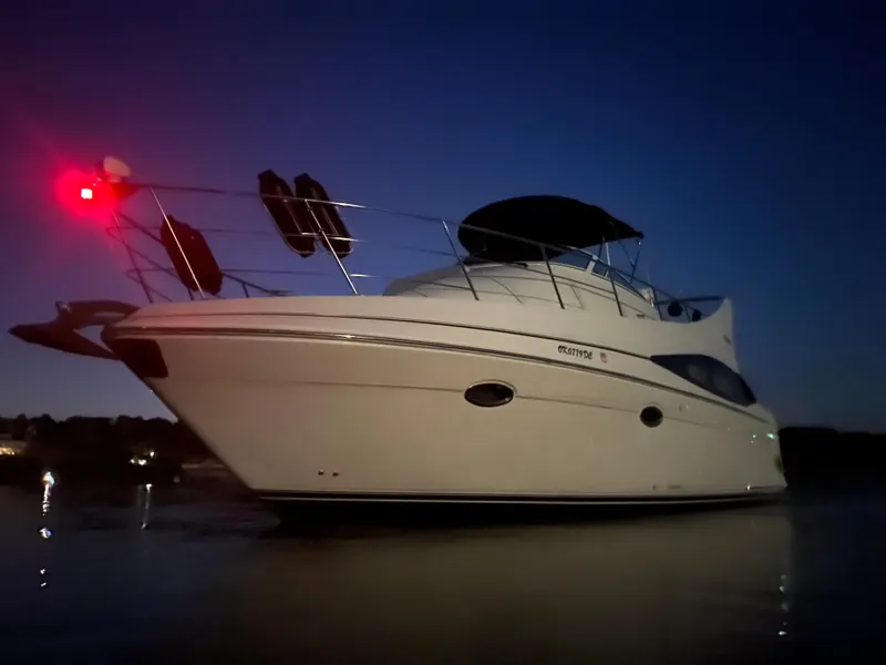 Slide: The Image of 2005 Carver 36 Mariner yacht at dusk with navigation lights on. - 3