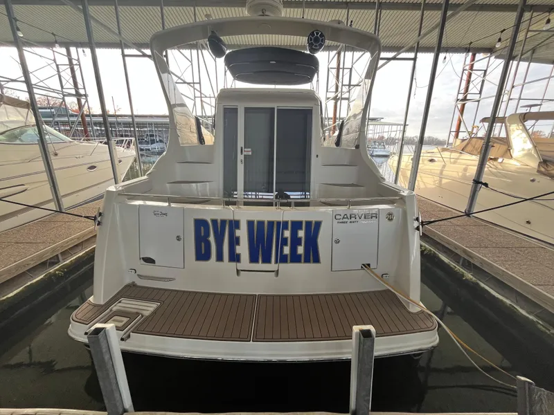 Slide: The Image of 2005 Carver 36 Mariner yacht docked, rear view with "Bye Week" text. - 4