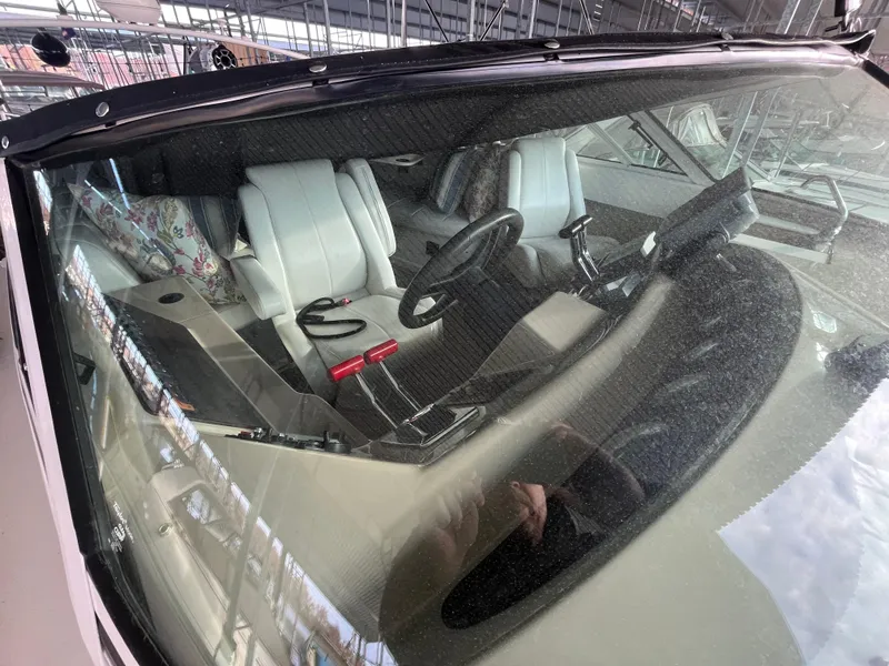 Slide: The Image of Interior view of 2005 Carver 36 Mariner boat, featuring steering wheel and seating. - 9