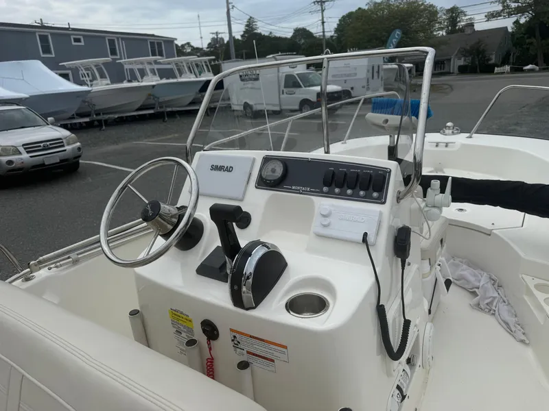 Slide: The Image of 2023 Boston Whaler 170 Montauk boat console with steering wheel and controls. - 4