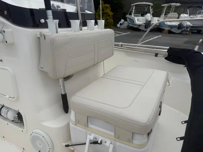 Slide: The Image of 2023 Boston Whaler 170 Montauk boat interior with cushioned seating and rod holders. - 5